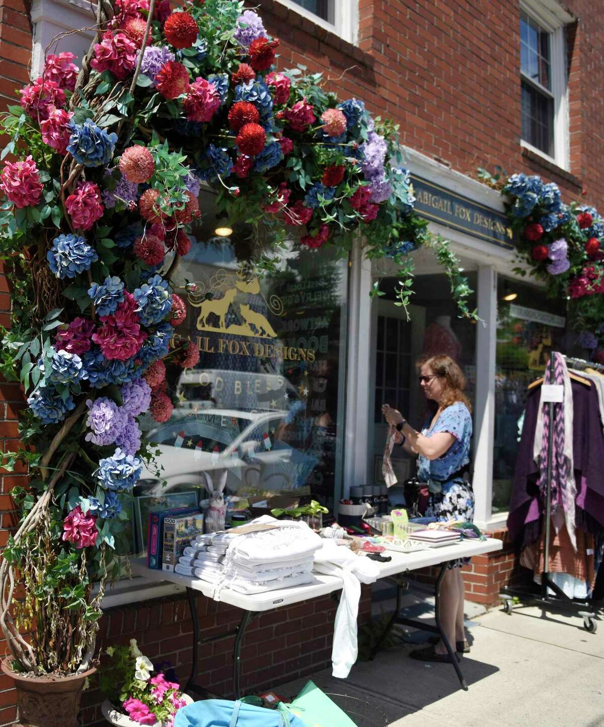 Stamford's Roseanne Hurvitz browses items at Abigail Fox Designs during the Old Greenwich Merchants Association Sidewalk Sales in Old Greenwich, Conn. Thursday, June 23, 2022. More than 20 local businesses participated in the sale, putting marked down items outside along the sidewalk of Sound Beach Avenue. The sidewalk sale continues through Sunday.
