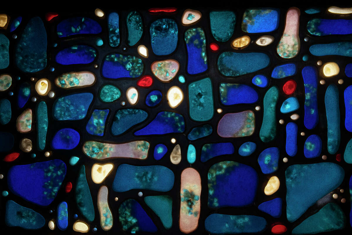Stained glass window at Congregation Gates of Heaven created in 1962 by artist Charles Van Atten shows how the Schenectady native was influenced by Picasso in this abstract night sky. Van Atten's designs are composed of cells, some as small as pebbles, that he filled with colorant and crushed stained glass. (Lori Van Buren/Times Union)