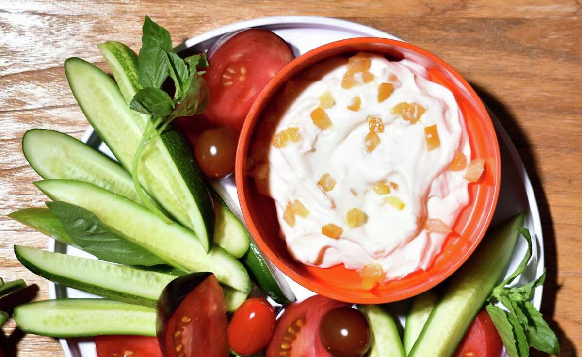 Preserved lemon enriches mayonnaise for a cucumber and tomato plate.