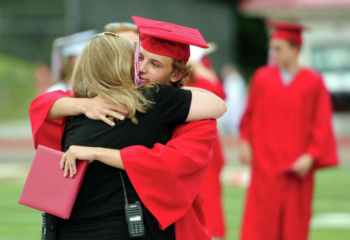 Thomas Foster hugs his mother Karen after getting his diploma on Thursday.