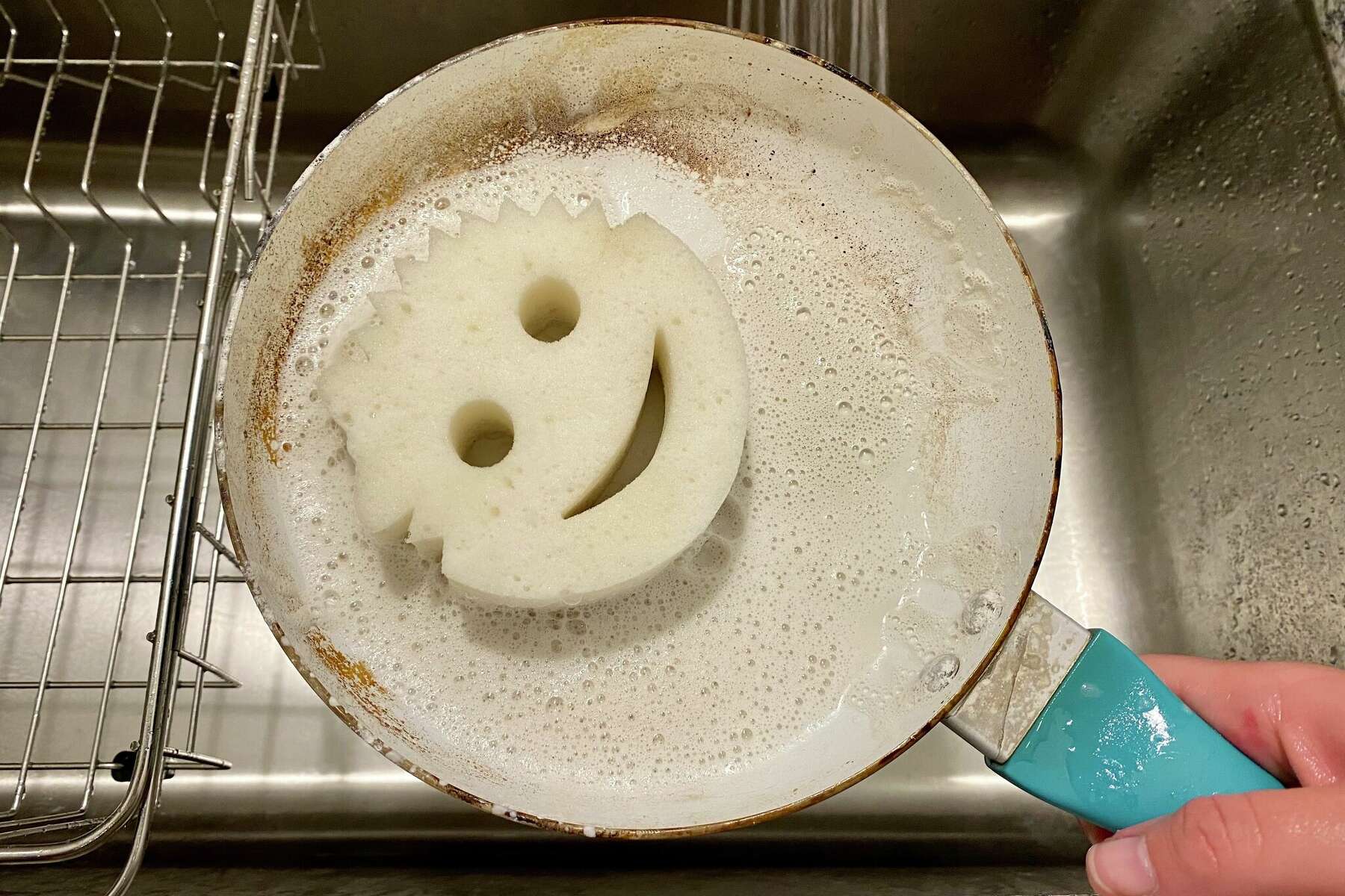 Happy face sponge made a dried happy face in the pan I didn't finish  washing last night. : r/mildlyinteresting