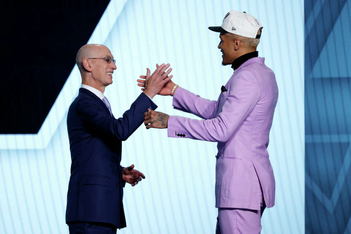 NBA commissioner Adam Silver (L) and Jeremy Sochan react after Sochan was drafted with the 9th overall pick by the the San Antonio Spurs during the 2022 NBA Draft at Barclays Center on June 23, 2022 in New York City.