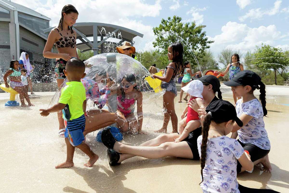 Kids escape the heat this week running through the water at the splash pad at Pearsall Park.