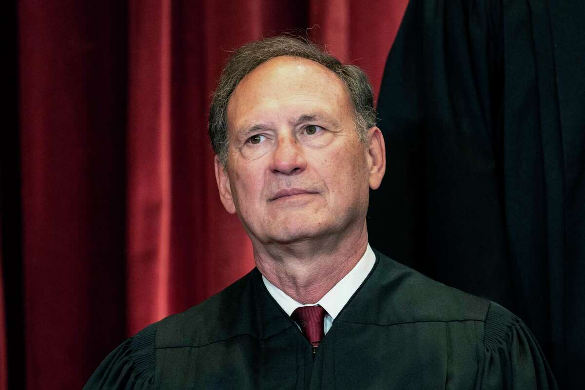 FILE - Associate Justice Samuel Alito sits during a group photo at the Supreme Court in Washington, April 23, 2021. The Supreme Court has ended constitutional protections for abortion that had been in place nearly 50 years — a decision by its conservative majority to overturn the court's landmark abortion cases. (Erin Schaff/The New York Times via AP, Pool, File)
