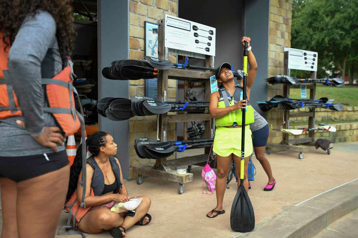 Missy Wilson explains how to use the paddle board paddle at the Riva Row Boat House Saturday, June 18, 2022, in The Woodlands, Texas.