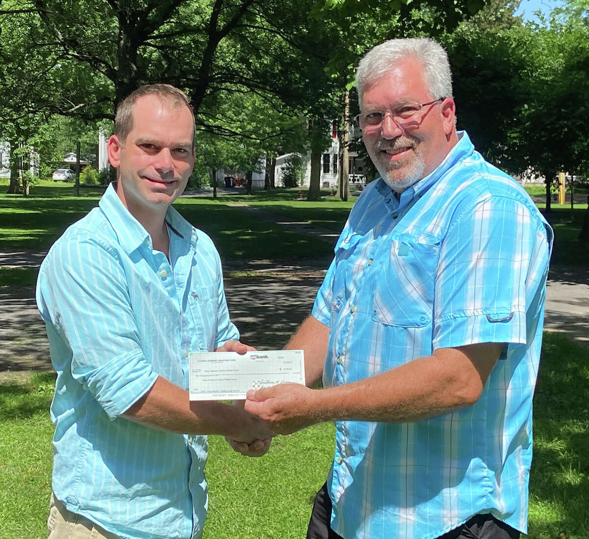 Bobby Carroll (right), secretary of Wadley Lodge No. 616, presents a check to Green Pastures board Chairman Travis Deaver. The check represents grant funding from the Illinois Masonic Children's Assistance Program.