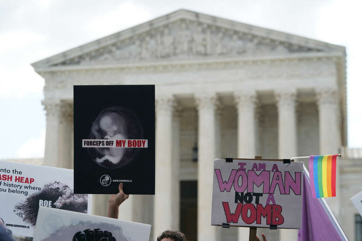 Pro-choice and pro-life signs are seen outside the US Supreme Court in Washington, DC, on June 24, 2022. - The US Supreme Court on Friday ended the right to abortion in a seismic ruling that shreds half a century of constitutional protections on one of the most divisive and bitterly fought issues in American political life. The conservative-dominated court overturned the landmark 1973 "Roe v Wade" decision that enshrined a woman's right to an abortion and said individual states can permit or restrict the procedure themselves. (Photo by Olivier DOULIERY / AFP) (Photo by OLIVIER DOULIERY/AFP via Getty Images)