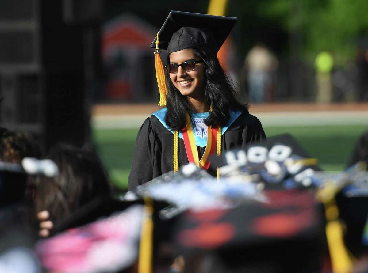 Shelton High valedictorian Ashley Jacob heads back to her seat after delivering her address at graduation on Thursday.