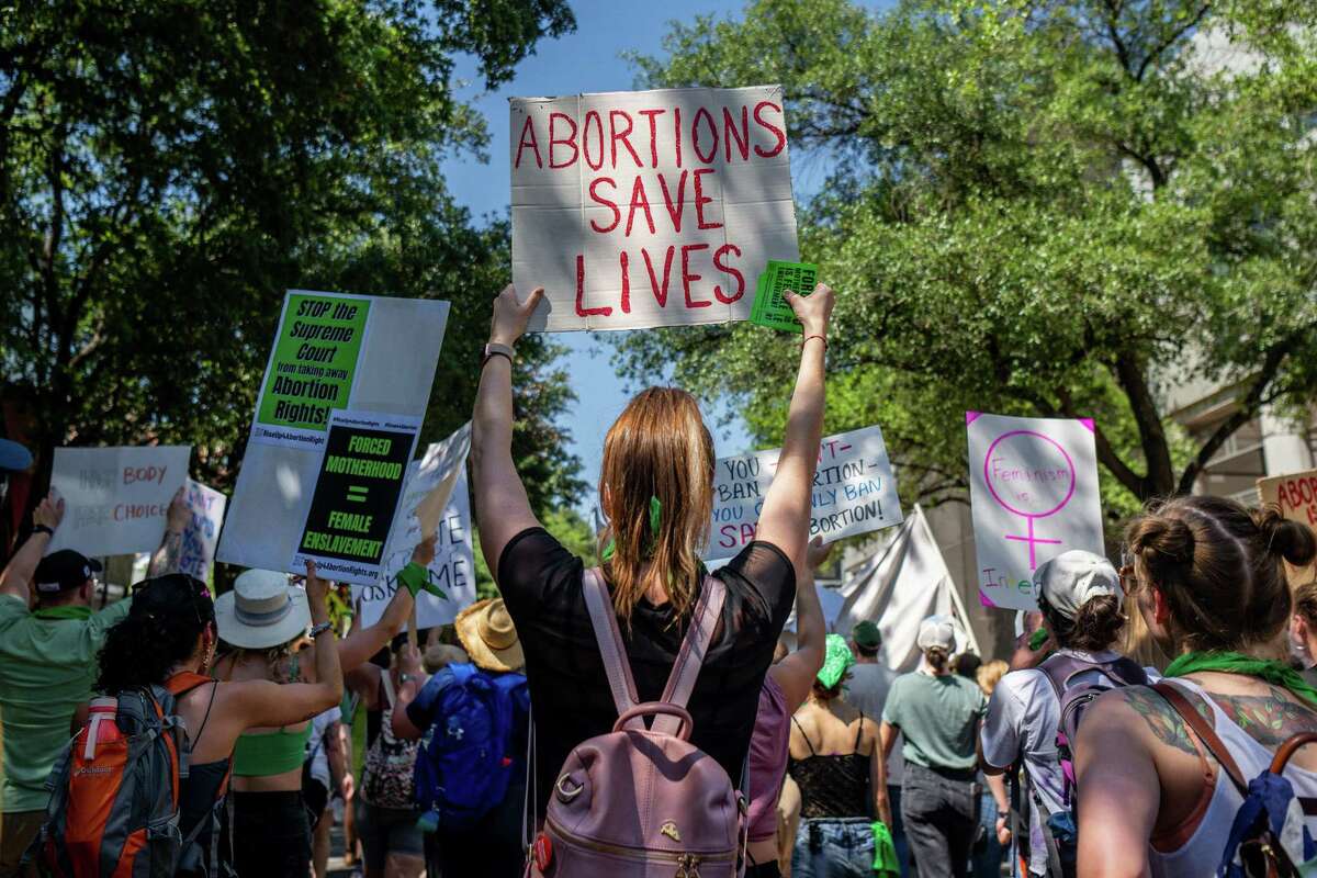 Abortion rights activists and supporters march outside of the Austin Convention Center where the American Freedom Tour with former President Donald Trump is being held on May 14, 2022 in Austin, Texas. (Brandon Bell/Getty Images/TNS)