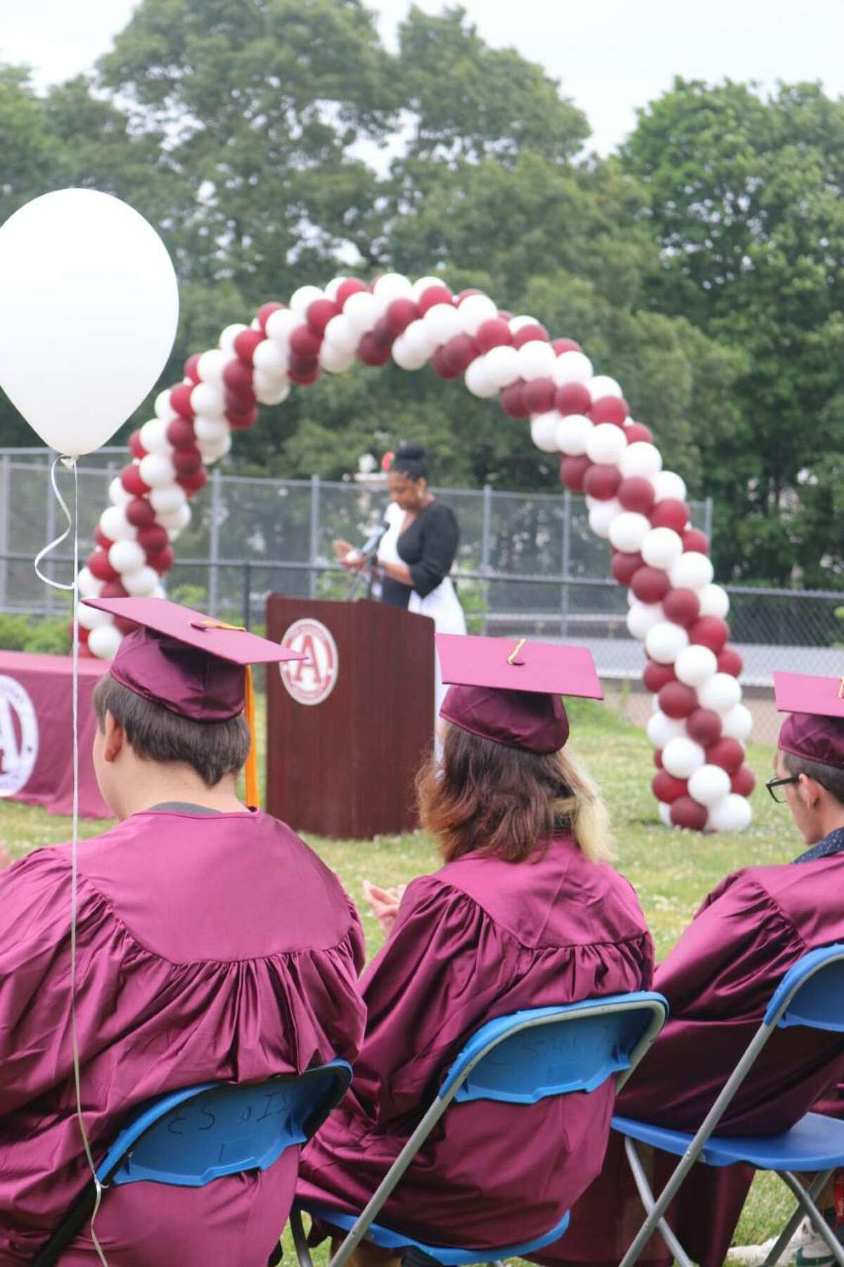 Academy Principal Dr. Danyelle Williams addresses the graduates at the alternative high school's commencement ceremony on June 16, 2022.
