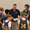 The Manistee boys basketball team huddles around coach Zack Bialik during a scrimmage against Marion on June 22 at Cadillac High School. 