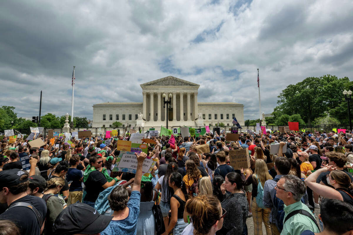 WASHINGTON, DC - JUNE 24: People protest in response to U.S. Supreme Court overturning Roe v. Wade on June 24, 2022 in Washington, DC. 