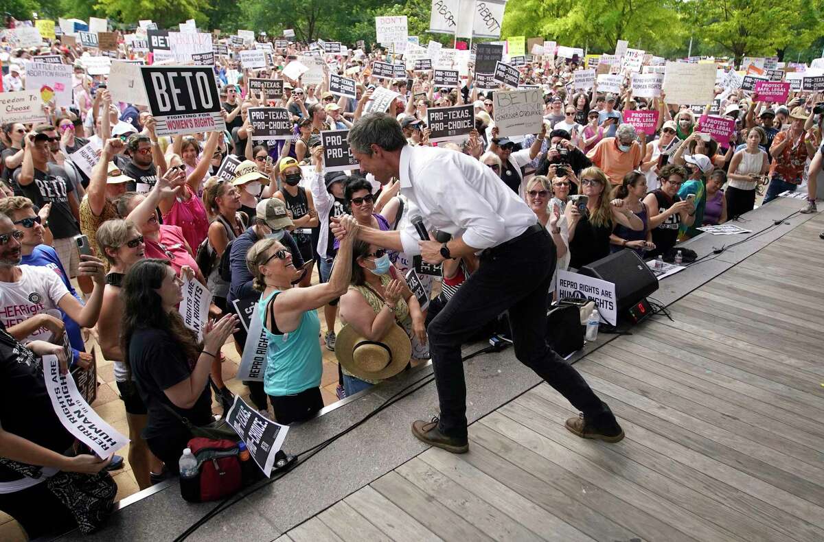 Beto O’Rourke high-fives a woman from the stage after speaking to a large crowd during an abortion rights rally organized by Beto O’Rourke at Discovery Green on Saturday, May 7, 2022 in Houston.