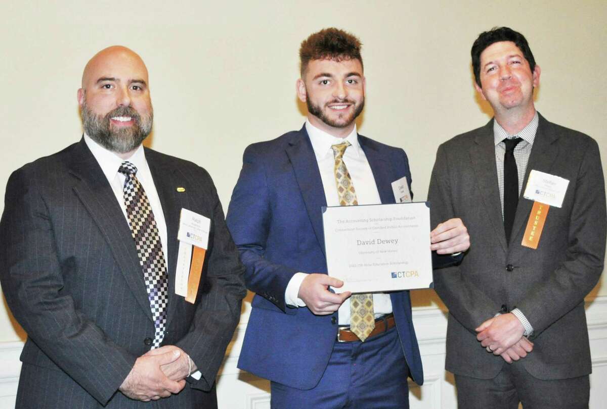 University of New Haven student David Dewey of Cromwell, center, accepts the 150-hour education scholarship from Connecticut Society of CPAs Accounting Scholarship Foundation Chairman Ralph Anderson III of Beers, Hamerman, Cohen & Burger, PC, left, and trustee Stefan Prins of PKF O’Connor Davies, LLP.