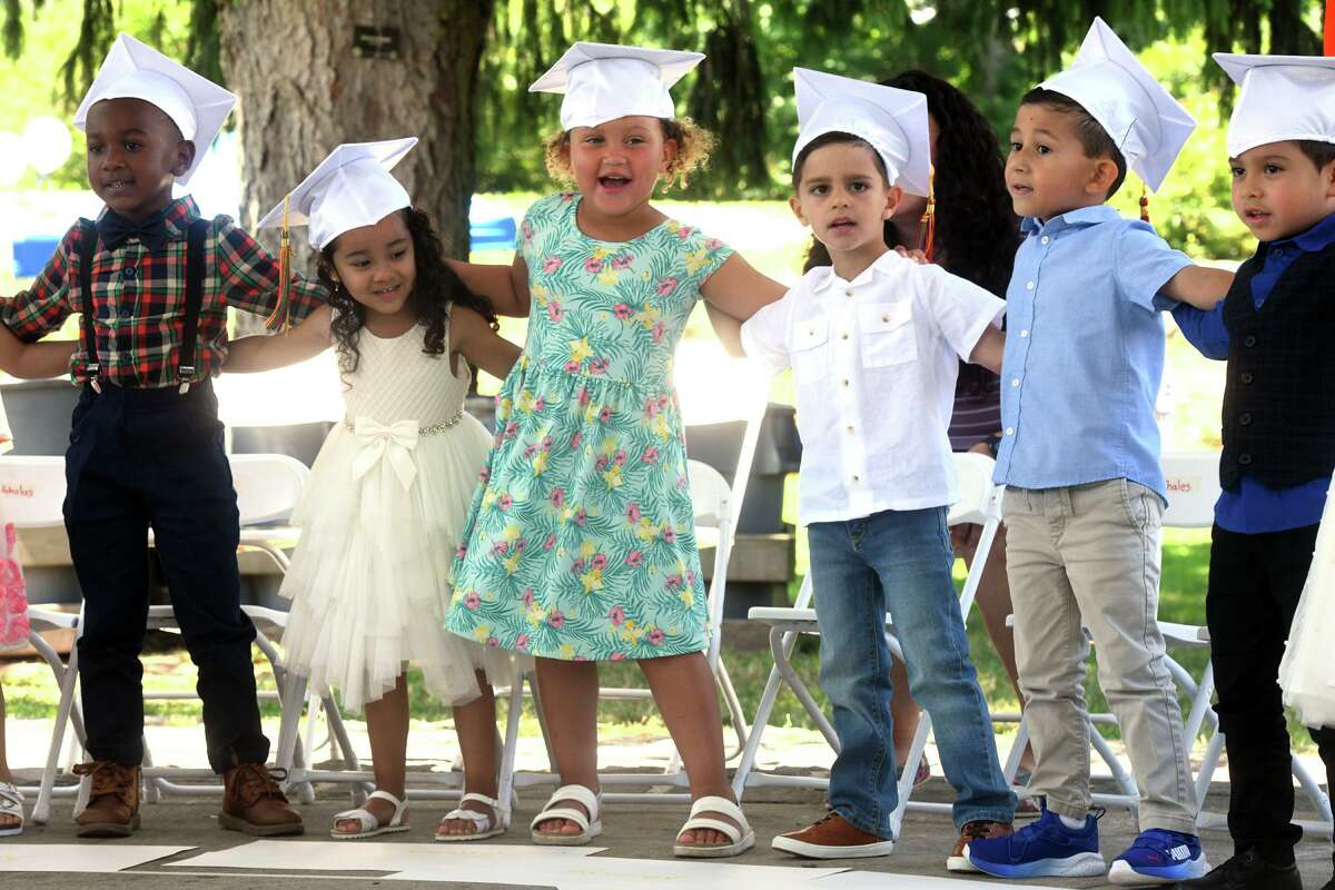 Students dance and sing during a graduation ceremony for Armstrong Court Preschool, held at Byram Park in Greenwich, Conn. June 24, 2022.