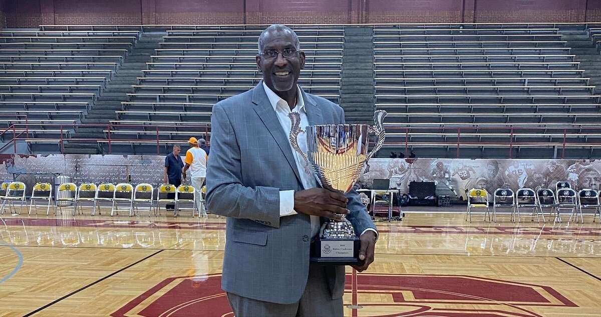Kokomo BobKats coach Cliff Levingston, who played 11 years in the NBA, poses with the team's TBL Midwest Division title trophy.