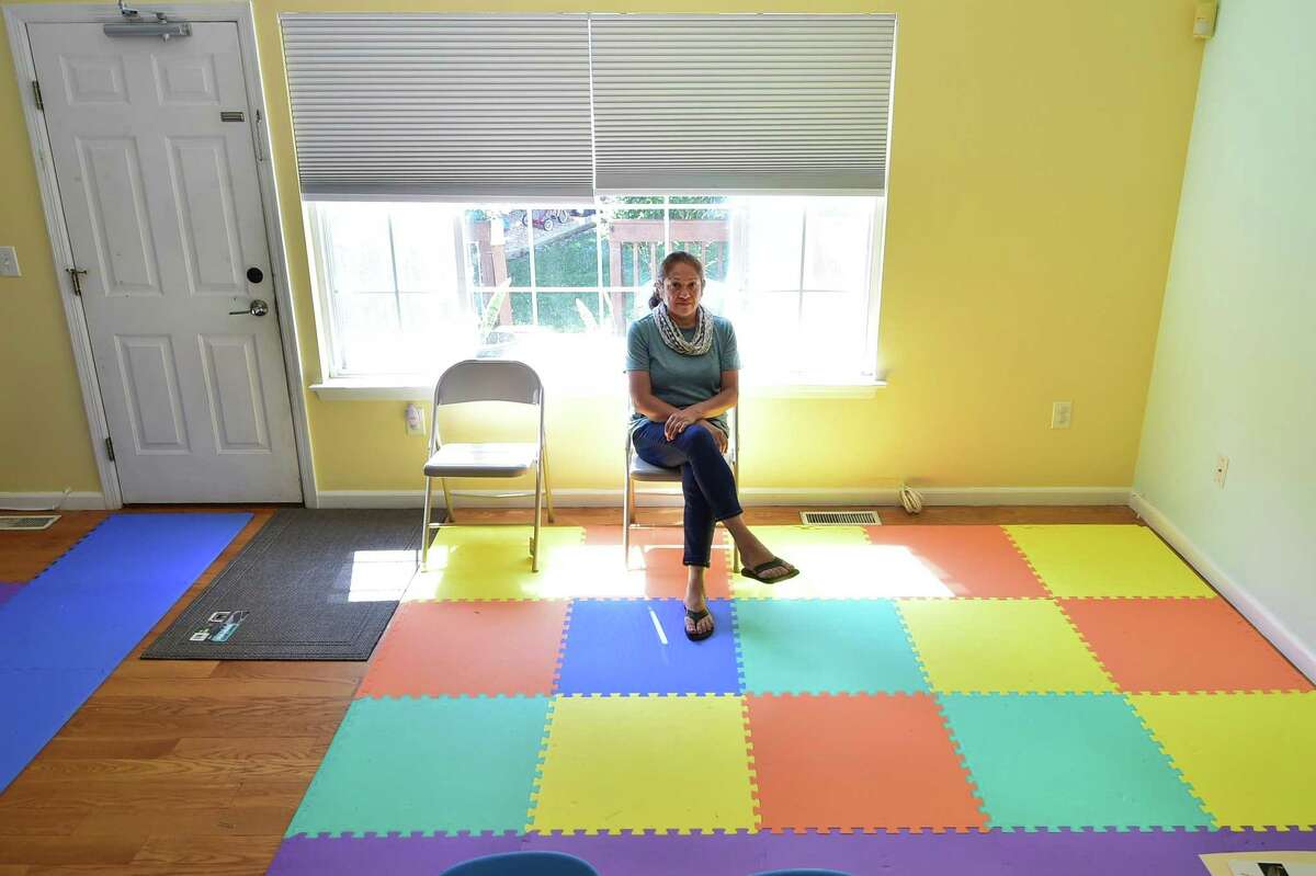 Gladys Cardona, who runs Shiny Rocks Daycare, poses in the empty side of her daycare that she would like to expand into, in Stamford, Conn., on Wednesday June 15, 2022. Child care providers, like Cardona, are flush with demand, but there's a problem for providers throughout Stamford. They argue that the local zoning process is more restrictive than the state licensing requirement.