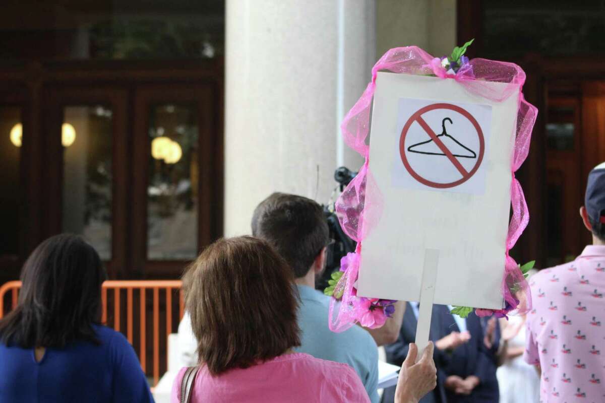 Connecticut residents carried signs and wore shirts in support of abortion rights at a rally on the steps of the state Capitol in Hartford Friday after an announcement from the Supreme Court that Roe v. Wade would be overturned.