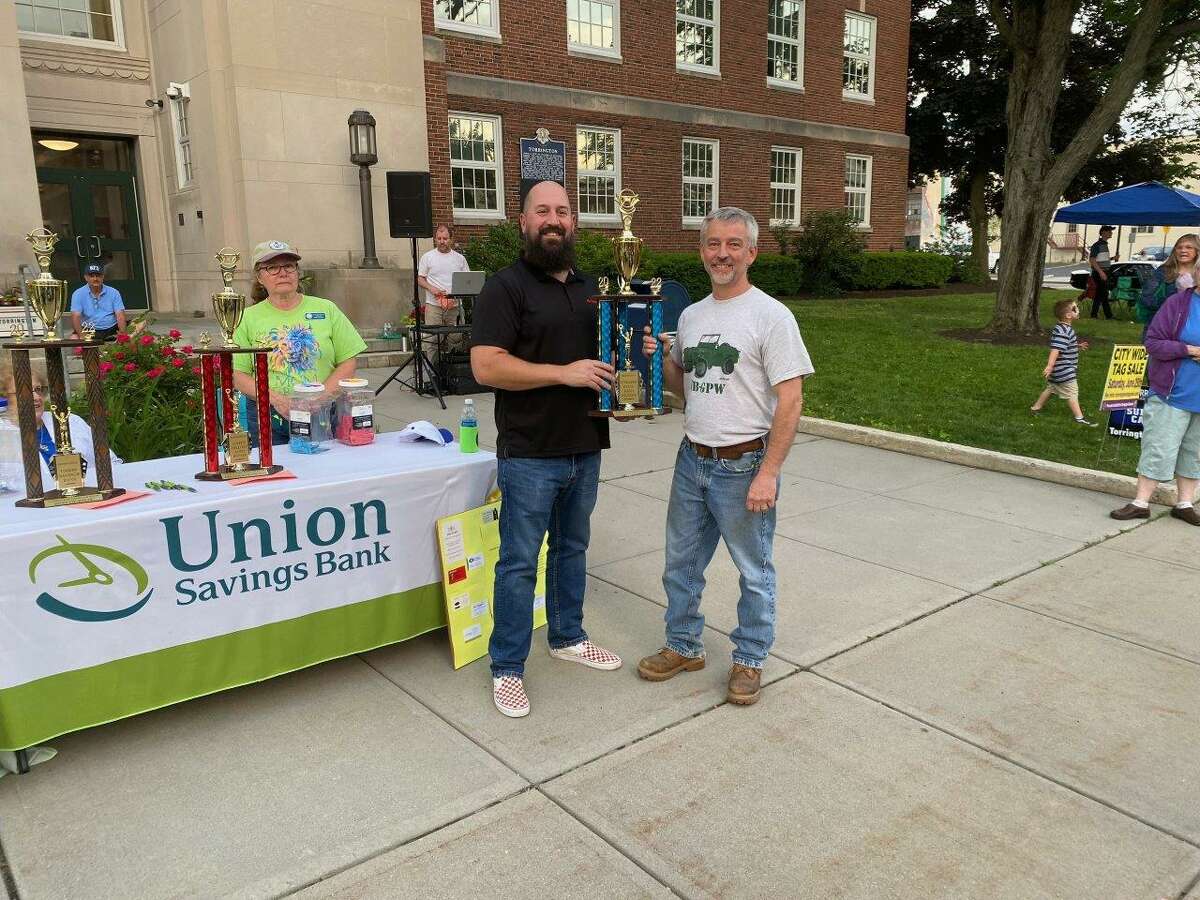 The annual Torrington Lions Club Car Show was held June 3 on Main Street, Torrington. State Farm representative and sponsor Jeremy Comandini presented the Show Committee trophy to Tom Stanfield.