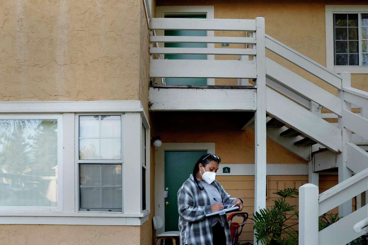Cristal Little knocks on doors to alert renters of a rent relief program at the Sundance Apartments, Tuesday, March 29, 2022, in Vallejo, Calif. Little warned renters about the upcoming March 31 deadline for California’s unprecedented $5.2 billion pandemic rent relief program.