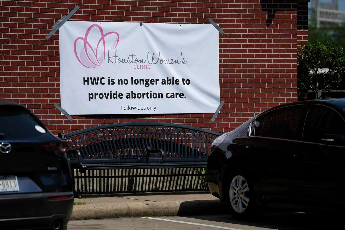 A sign at Houston Women’s Clinic on Friday informs patients that abortion care there has ended.