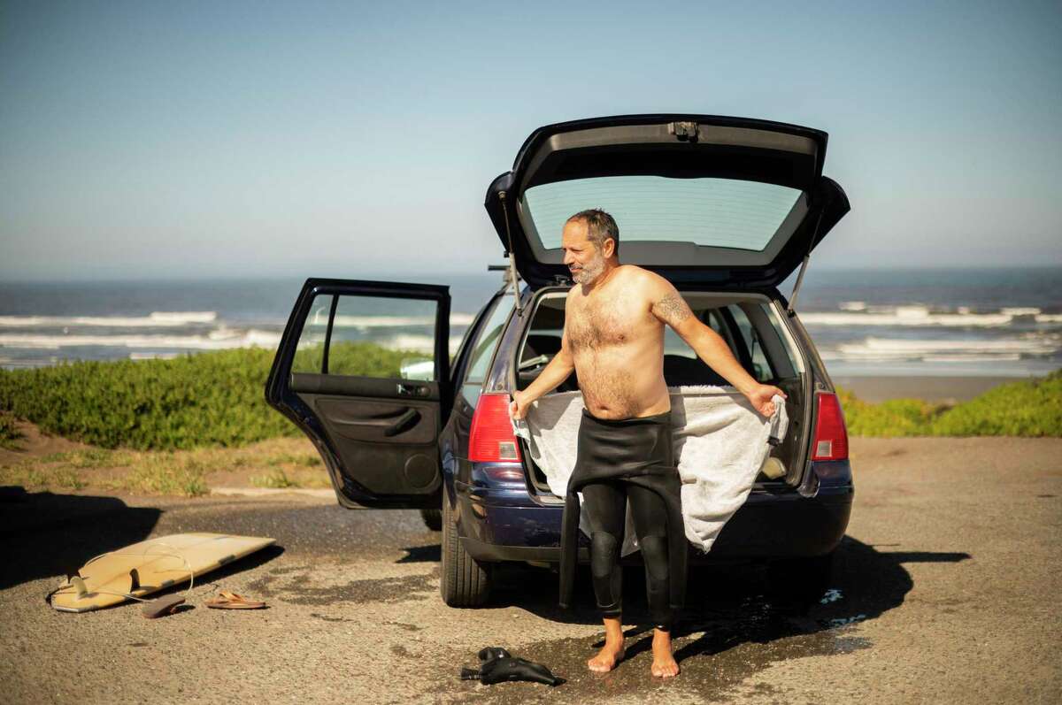 Brian Lilla of Napa tries to warm up after a short surfing session at Salmon Creek.