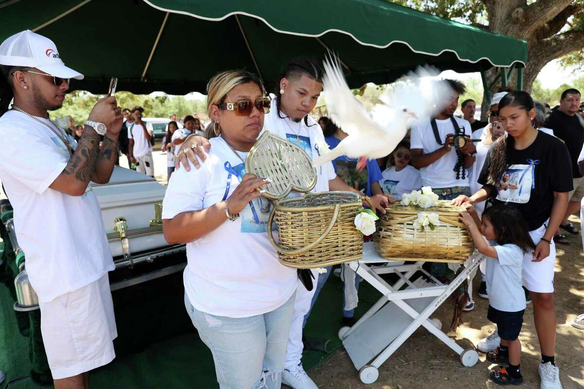 Lynda Espinoza releases a white dove symbolizing her son’s spirit during his burial service. Family and activists say they will pursue justice for the boy.