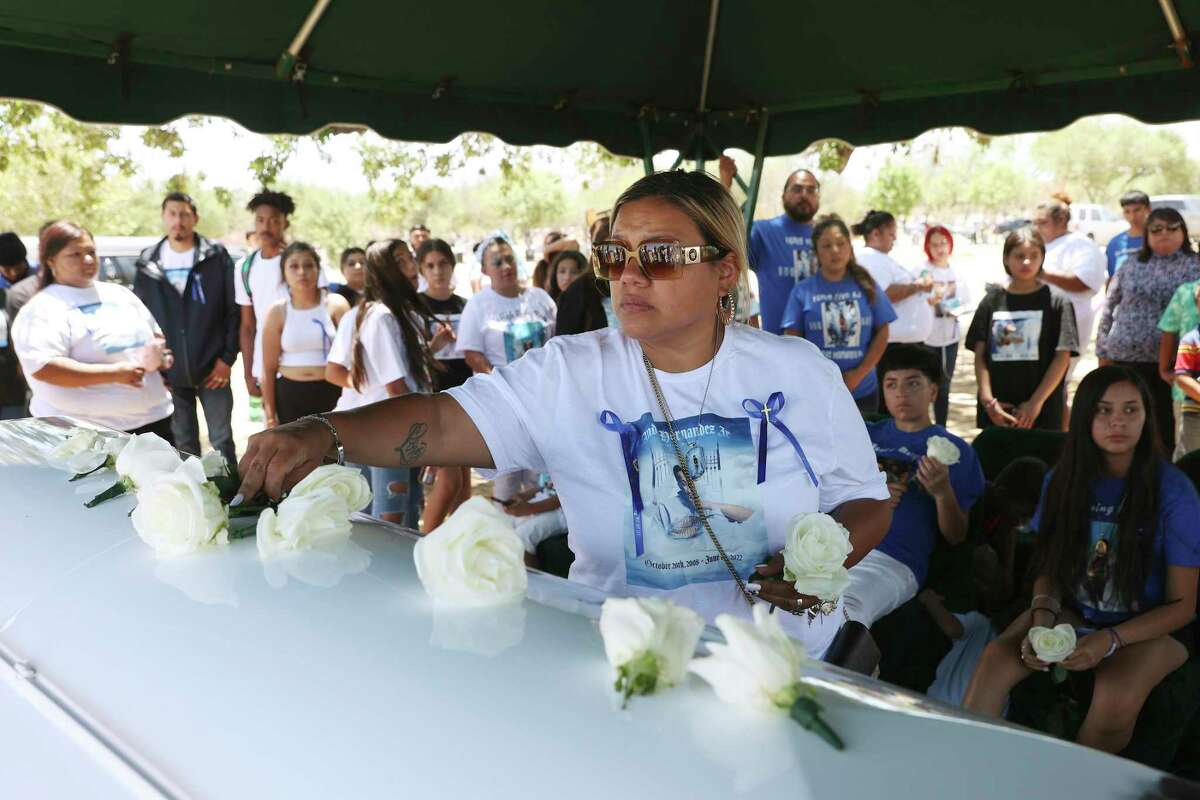 Lynda Espinoza places white roses on the casket of her son, 13-year-old Andre “AJ” Joseph Hernandez, during burial services at First Memorial Park Cemetery on Friday, June 24, 2022. The boy was shot and killed in a confrontation with San Antonio police June 3 on the city’s Southwest Side.