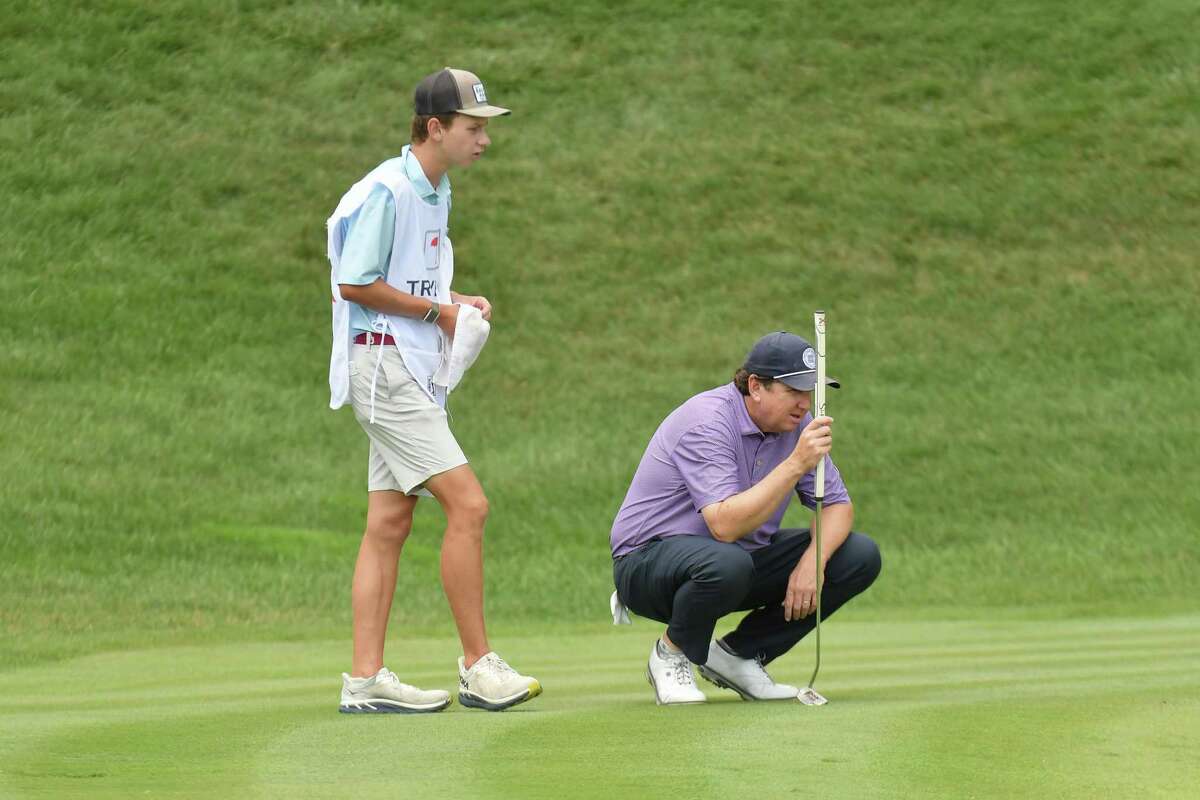 J.J. Henry, who grew up in Fairfield. competes in the second round of the Travelers Championship. His son, Connor, 17, is his caddy this week.