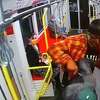 Nesta Bowen, 27, seen in an orange and red shirt, apparently attacking Javon Green, 26, with an object that appears to be a knife. This still shot, which was captured by surveillance footage on Muni, was recorded just before officials said Green fatally shot Bowen and injured a 70-year-old man.