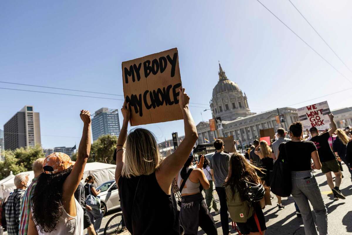Protesters march toward San Francisco City Hall in response to the U.S. Supreme Court ruling to overturn Roe v. Wade on Friday.