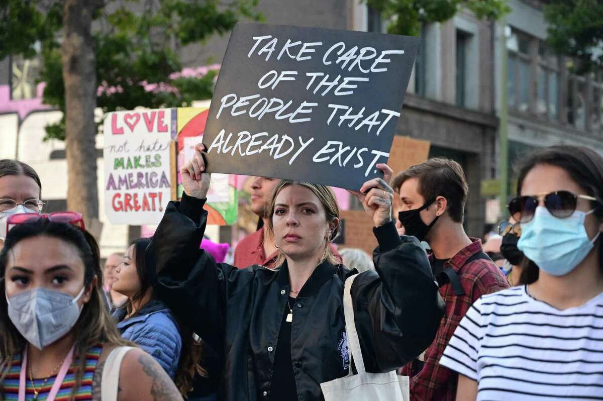 Protesters march on 14th Street toward Lake Merritt on Friday, June 24, 2022, in Oakland , Calif..
