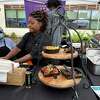 Kismet Douglass, proprietor of Momma Kiss Kitchen Cuisine, hard at work at the first-ever City Seed Dixwell Community "Q" House Farmers Market on Wednesday, June 22, 2022.