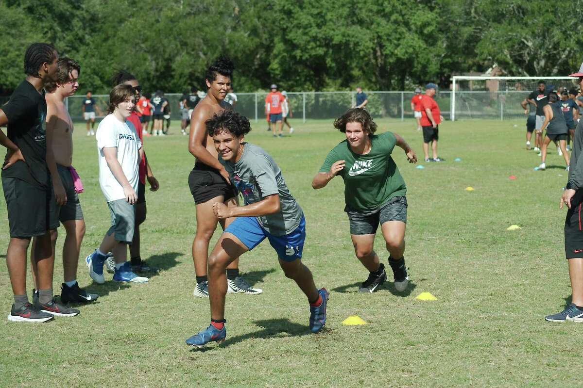 Dawson football players work hard in agility drills at the Dawson summer strength and conditioning camp.