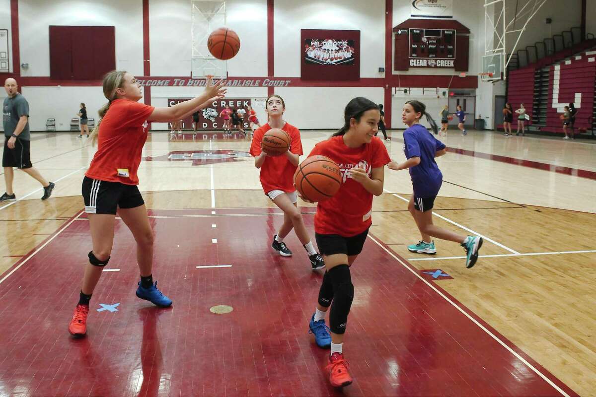 Avery Evans, Marcey Auttonberry, Jayden Golden and Pyper Trancucci participate in a shooting drill at the recent Clear Creek summer girls basketball camp.