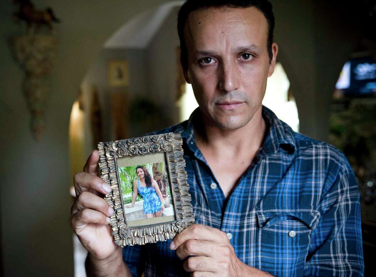 This Aug. 14, 2012 photo shows Ronald (Rony) Molina holding a photo of his wife in his home in Stamford, Conn., in 2012 Molina’s wife, Sandra, was deported to Guatemala in 2010, leaving Molina alone to care for their three children, all American citizens. Rony Molina was killed in a hit-and-run accident in Stamford in April 2022.