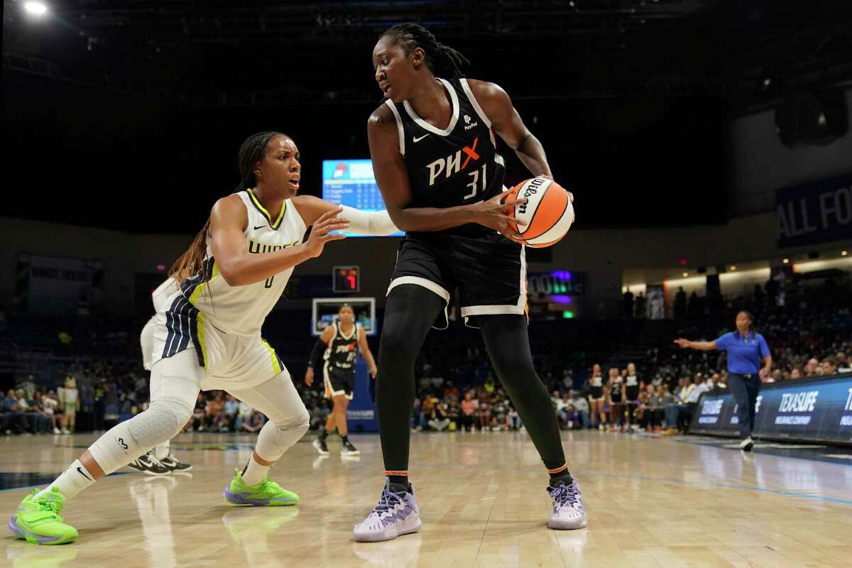 Dallas Wings' Kayla Thornton (6) defends as Phoenix Mercury's Tina Charles (31) works for a shot opportunity in a WNBA basketball game, Saturday, June 18, 2022, in Arlington, Texas. (AP Photo/Tony Gutierrez)
