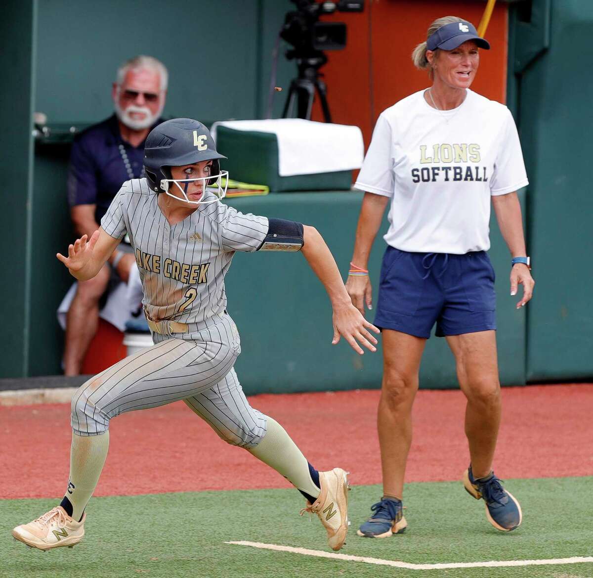 Maddie McKee #2 of Lake Creek looks back as she scores off of an RBI single by Carmen Uribe in the fourth inning of their Class 5A semifinal game during the UIL State Softball Championships at Red & Charline McCombs Field, Friday, June 3, 2022, Austin.