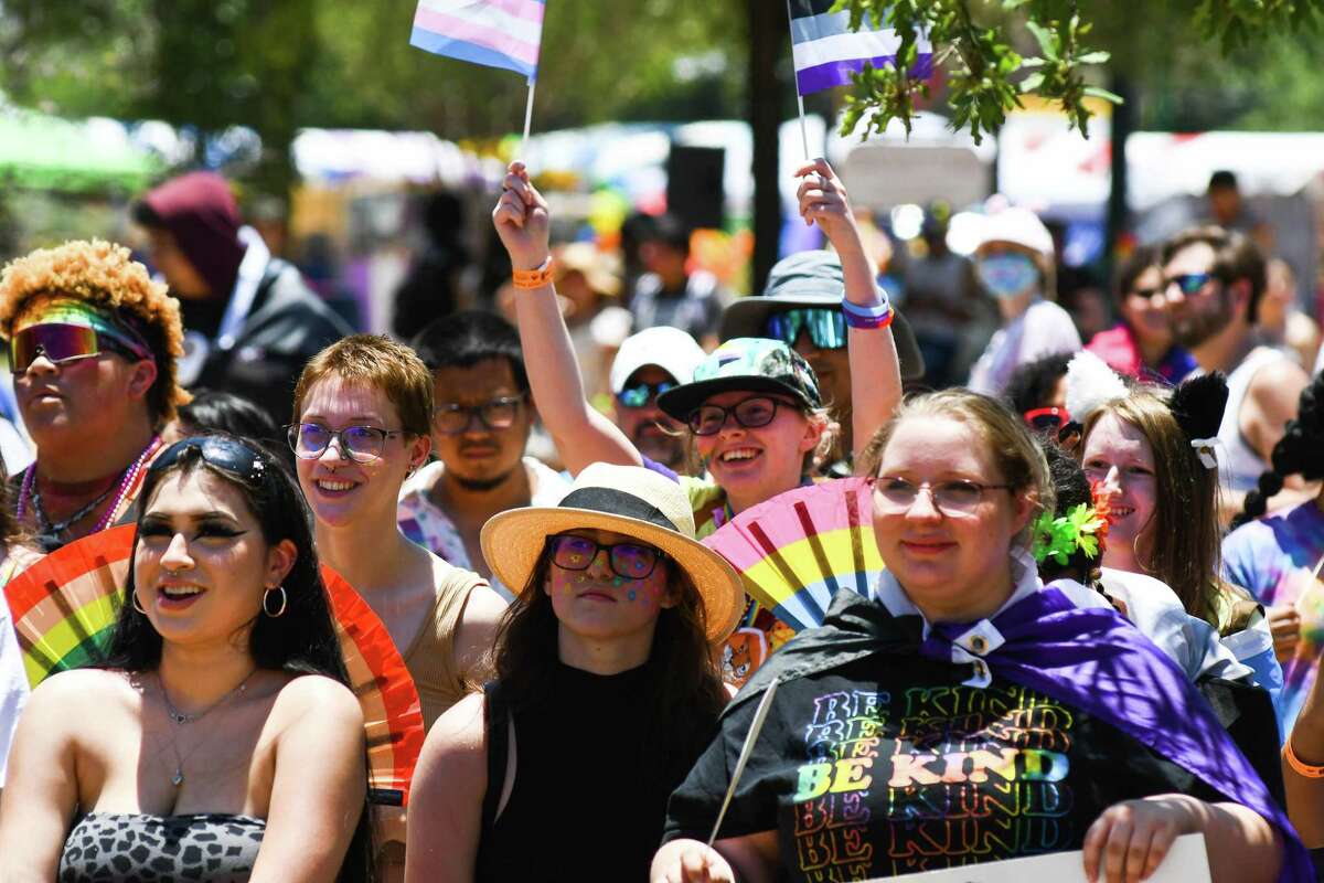 Festival attendees watch a show during the Pride Bigger Than Texas Parade and Festival-San Antonio at Crockett Park on Saturday, June 25, 2022.