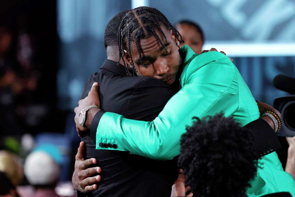 Tari Eason, hugging family after being picked by the Rockets in Thursday’s draft, always had support at home where his mom, Teroya, would often email highlights of his games to recruiting services.