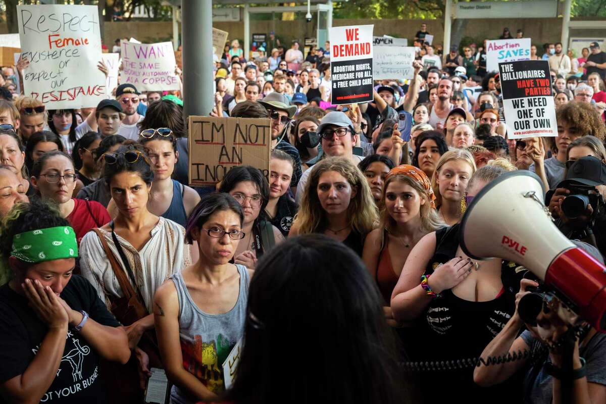 the crowd listens to a speaker during a protest in downtown Houston, Texas, on Friday, June 24, 2022.