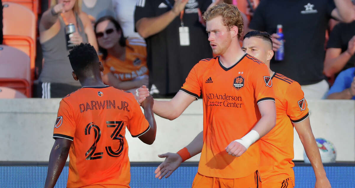 Houston Dynamo forward Darwin Quintero (23) and forward Thor Ulfarsson (34) celebrate the score by Ulfarsson during the first half of their MLS game against the Chicago Fire Saturday, June 25, 2022 in Houston, TX.