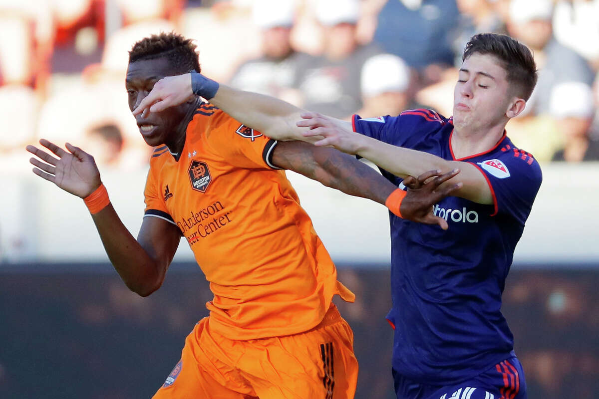 Houston Dynamo defender Teenage Hadebe, left, fends off Chicago Fire midfielder Brian Gutierrez, right, during the first half of their MLS game Saturday, June 25, 2022 in Houston, TX.