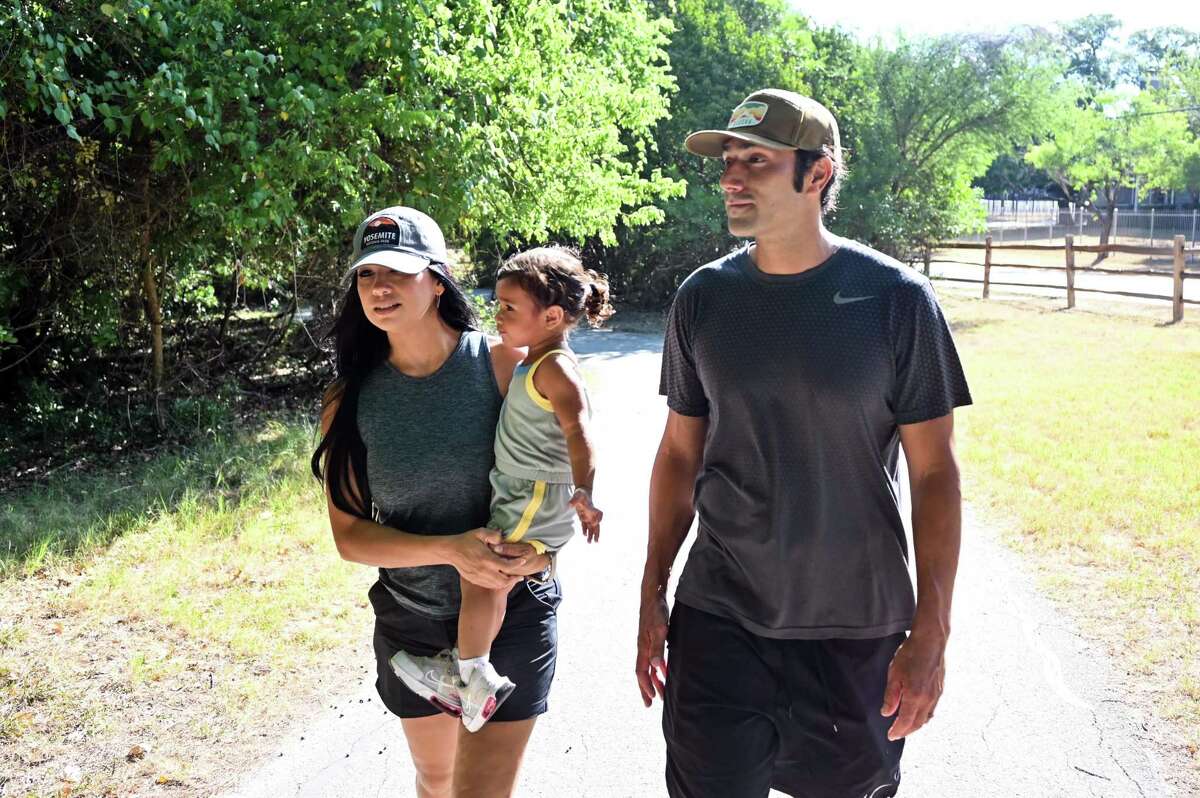 Valerie and Eric Castillo hike with their one-year-old daughter Journey at Denman Estate Park on June 25.