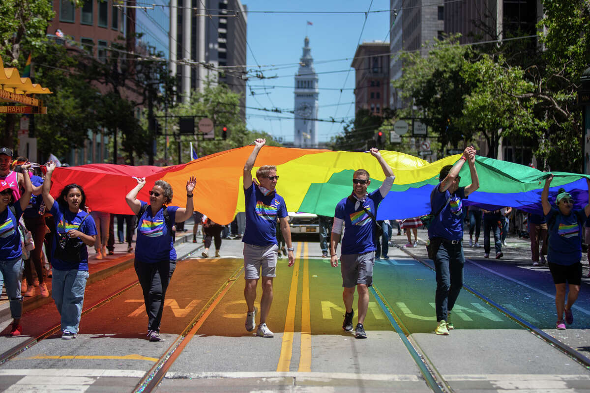 Participants hold a large rainbow flag during the San Francisco Pride Parade on June 26, 2022.