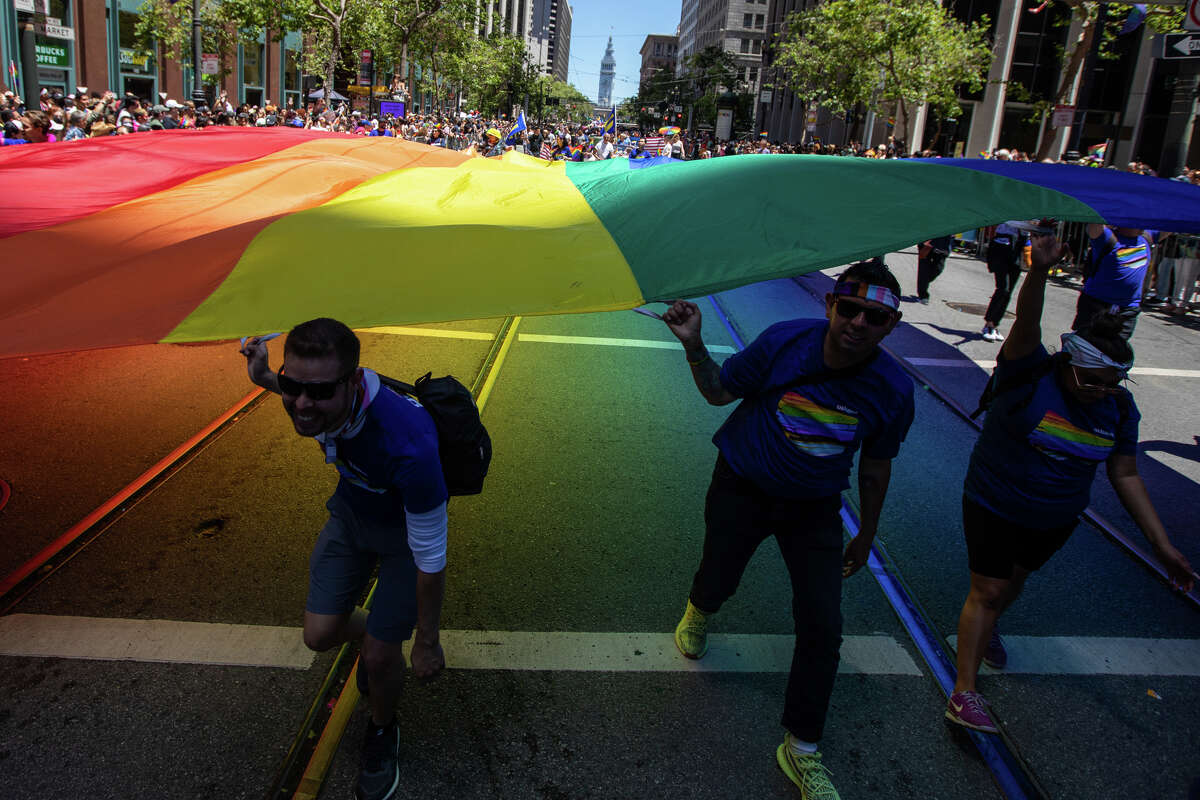 Participants hold a large rainbow flag during the San Francisco Pride parade in San Francisco, Calif. on June 26, 2022.