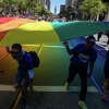 Participants hold a large rainbow flag during the San Francisco Pride parade in San Francisco, Calif. on June 26, 2022.