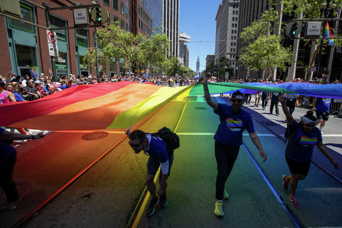 Participants hold a large rainbow flag during the San Francisco Pride parade in San Francisco, Calif.  on June 26, 2022.