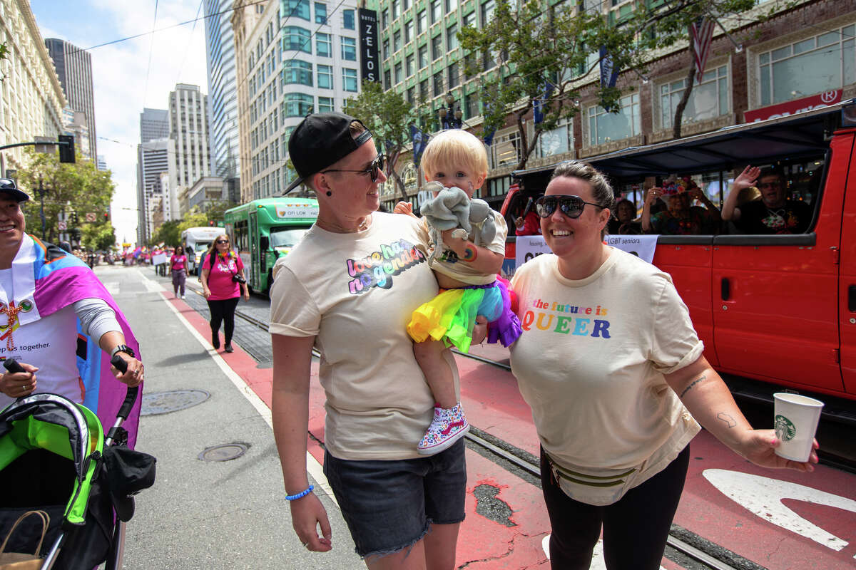 (Left to right) Courtney, Baker, and Elizabeth McKeegan take part in the the San Francisco Pride parade in San Francisco, Calif. on June 26, 2022.
