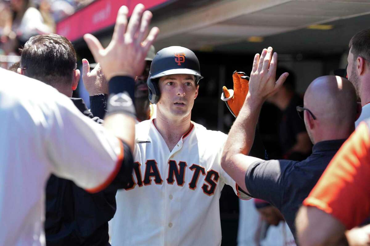 San Francisco Giants' Mike Yastrzemski is congratulated after hitting a home run against the Cincinnati Reds during the fourth inning of a baseball game Sunday, June 26, 2022, in San Francisco, Calif. (AP Photo/Darren Yamashita)